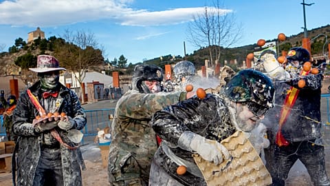 Revellers take part in the Els Enfarinats festival, in the town of Ibi near Alicante, Spain, Tuesday 28 Dec, 2021 