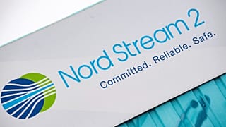 A sign reading "Nord Stream 2 Committed. Reliable. Safe." hangs above a painted map at the natural gas receiving station in Lubmin, Germany, on Nov. 16, 2021.