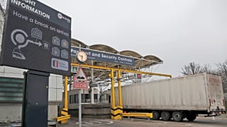Lorries pass the customs checkpoint at the Eurotunnel train link with Europe in Folkestone, England, on Jan. 1, 2021.