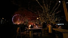 People have drinks at a Christmas market cafe in the historical center of Antwerp, Belgium, Monday, Dec. 20, 2021. 