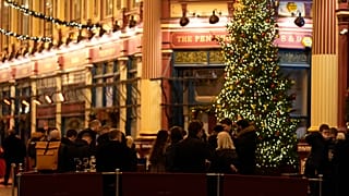 Customers drink outside a bar in London, Friday, Dec. 17, 2021. 