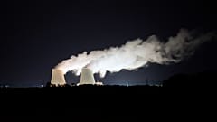 Steam escapes at night from the nuclear plant of Nogent-sur-Seine, 110 kms (63 miles) south east of Paris, Aug. 8, 2021. 