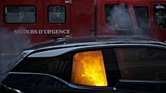 A firefighters truck parks by a burning car during a demonstration, Dec. 5, 2020 in Paris.