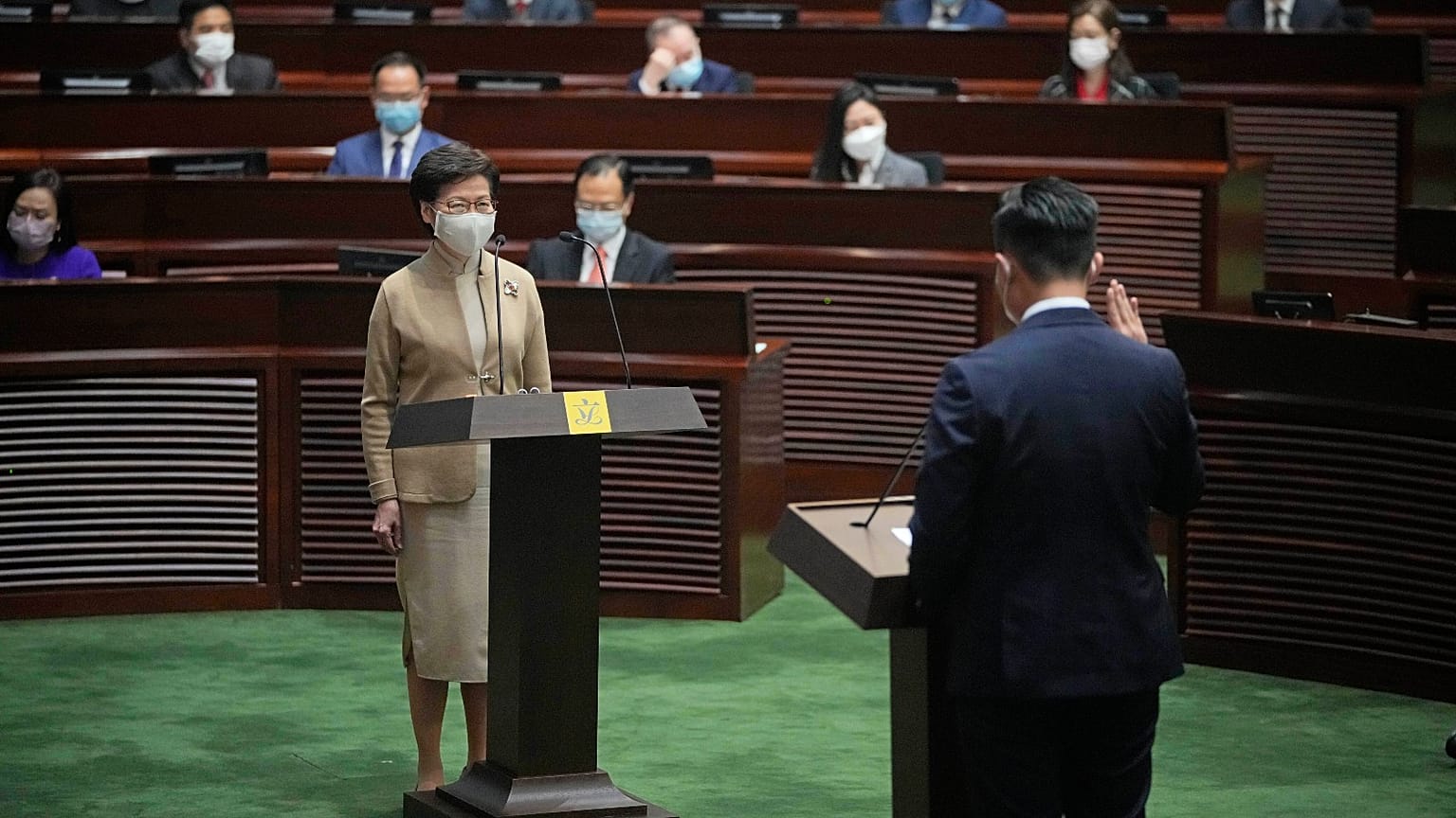 Newly elected pro-Beijing lawmaker Vincent Cheng Wing-shun, right, takes his oath in Hong Kong, Monday, Jan. 3, 2022.