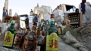 Booze bottles are piled up on rock to be smashed by Taliban authorites in Kabul, Afghanistan, Tuesday, Aug.28, 2001.