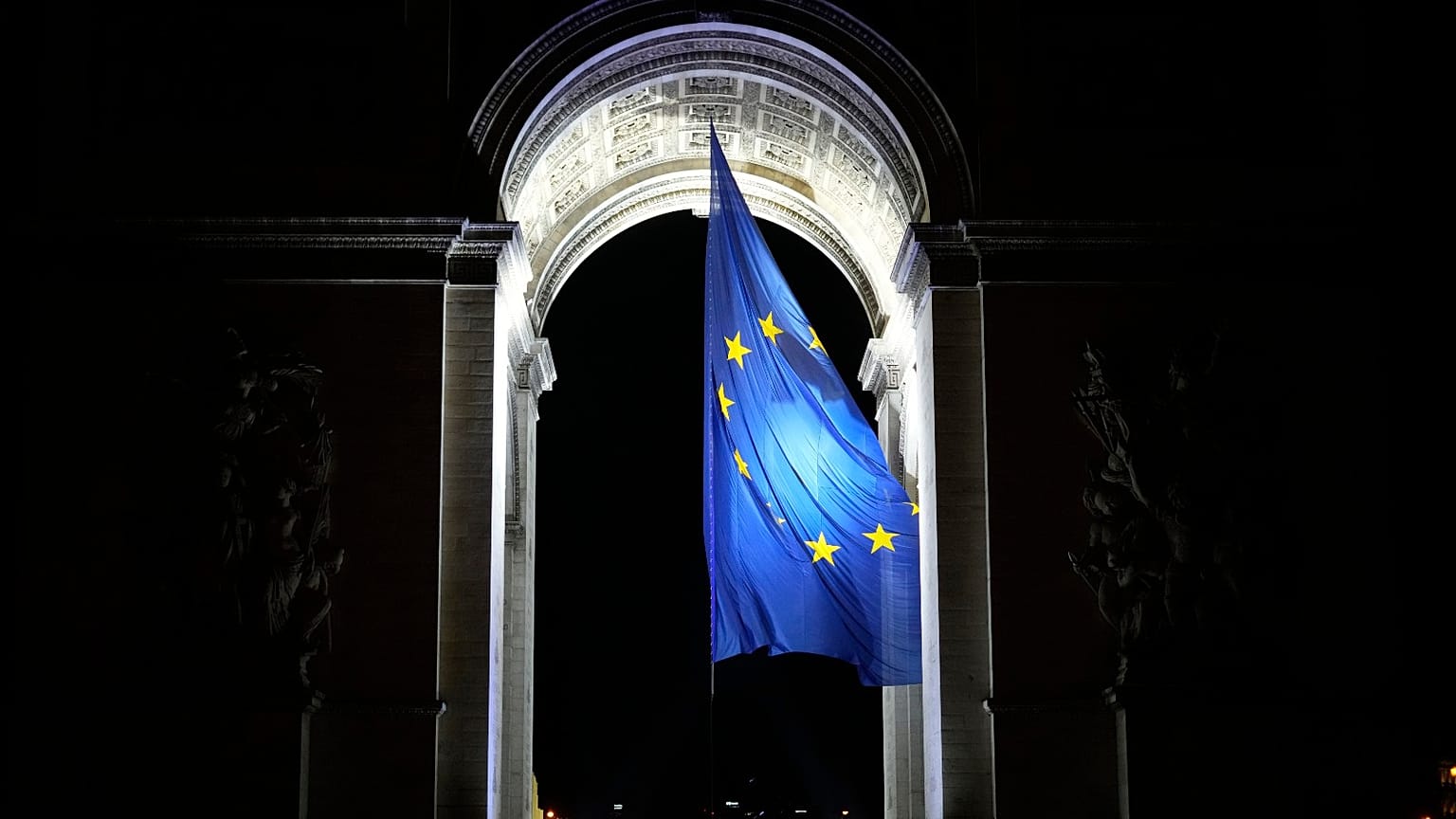 The European flag flies under the Arc de Triomphe to mark France's EU presidency in Paris, France, Saturday, Jan. 1, 2022. 