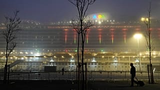 A man walks past the cruise ship AIDAnova docked in Lisbon, Monday, Jan. 3, 2022.