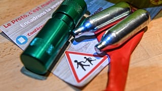Balloons and canisters filled with nitrous oxide, commonly known as laughing gas.