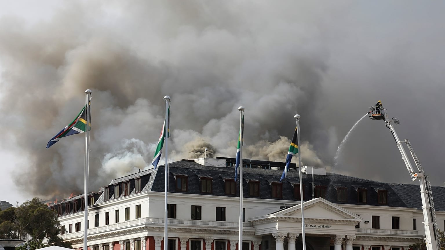 Smoke rises from the Parliament in Cape Town, South Africa, Monday, Jan 3, 2022 after the fire re-ignited late afternoon. 