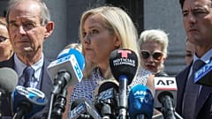 In this Aug. 27, 2019 file photo, Virginia Giuffre, center, who says she was trafficked by sex offender Jeffrey Epstein, outside a Manhattan court in New York.