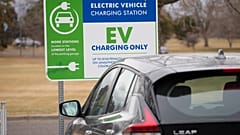 A Nissan Leaf charges at a recharge station outside the Denver Museum of Nature and Science Friday, Dec. 24, 2021.