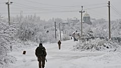 Ukrainian servicemen patrol Verkhnotoretske village near the frontline with Russia-backed separatists in the Yasynuvata district of Donetsk region.