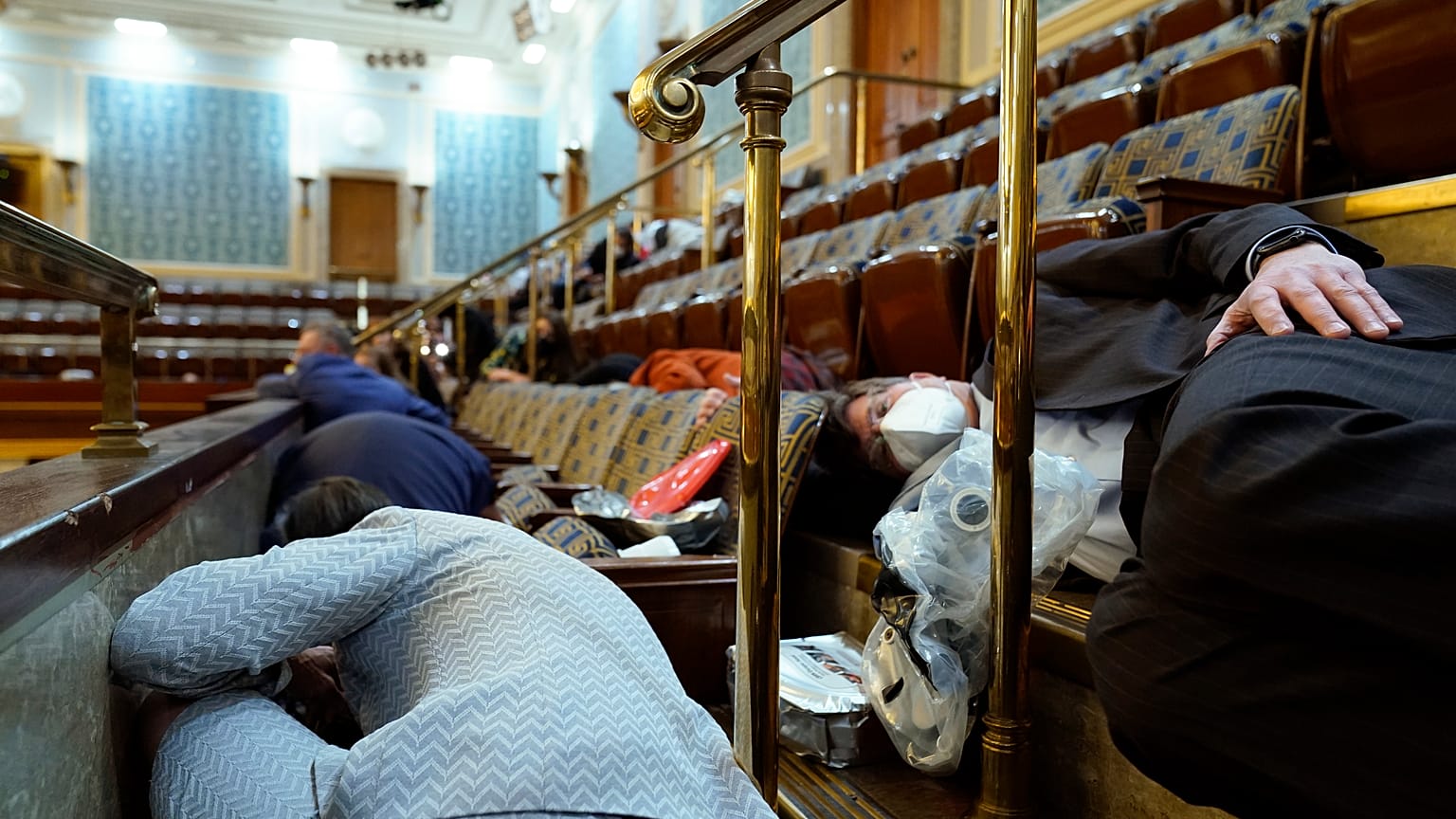 Members of Congress and others shelter in the House gallery as rioters try to break into the House Chamber at the US Capitol on Jan. 6, 2021, in Washington.