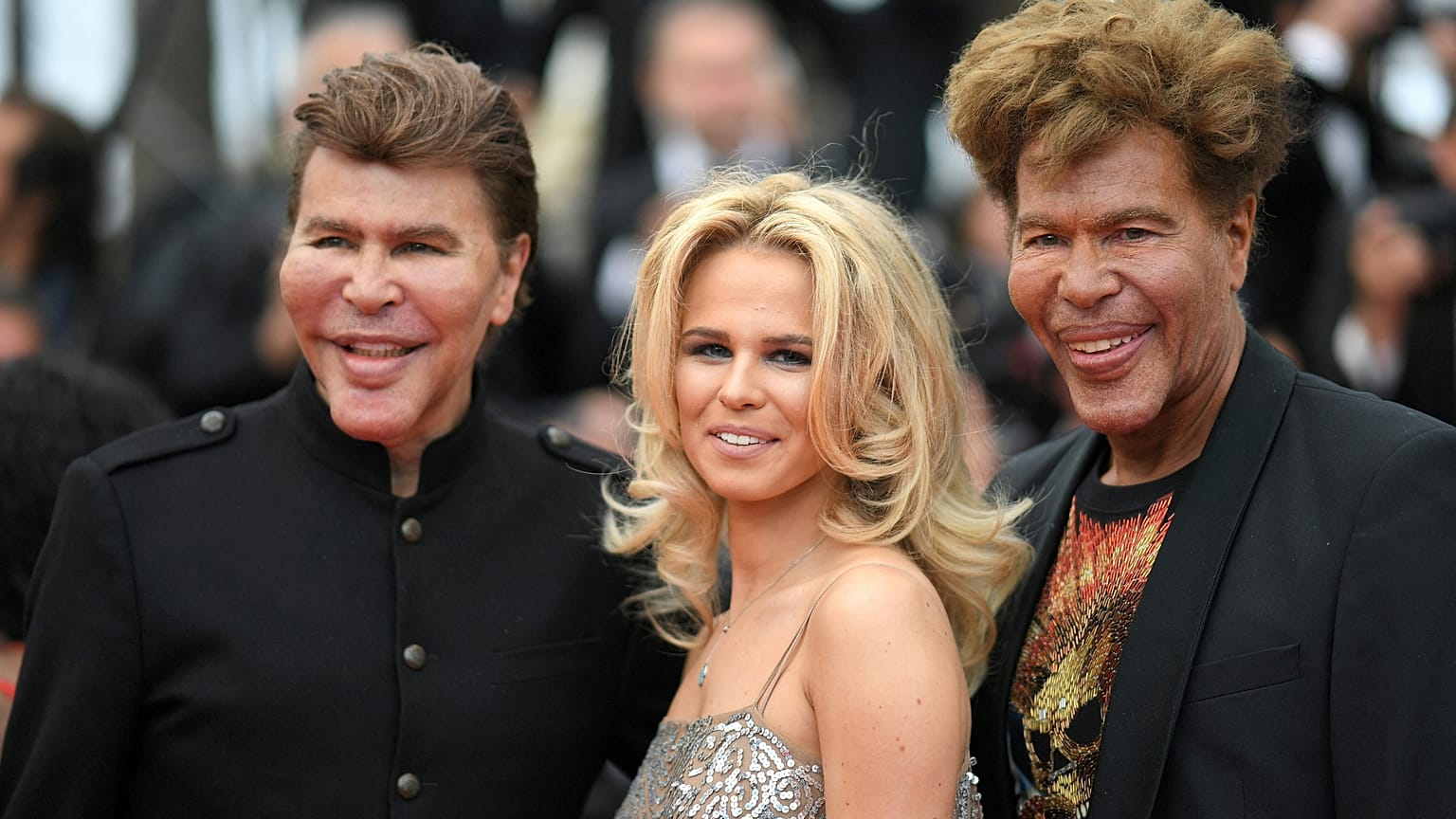 Igor Bogdanoff (R) and his partner Julie (C) and twin-brother Grichka Bogdanoff (L) arrive at the 71st edition of the Cannes Film Festival on May 15, 2018.