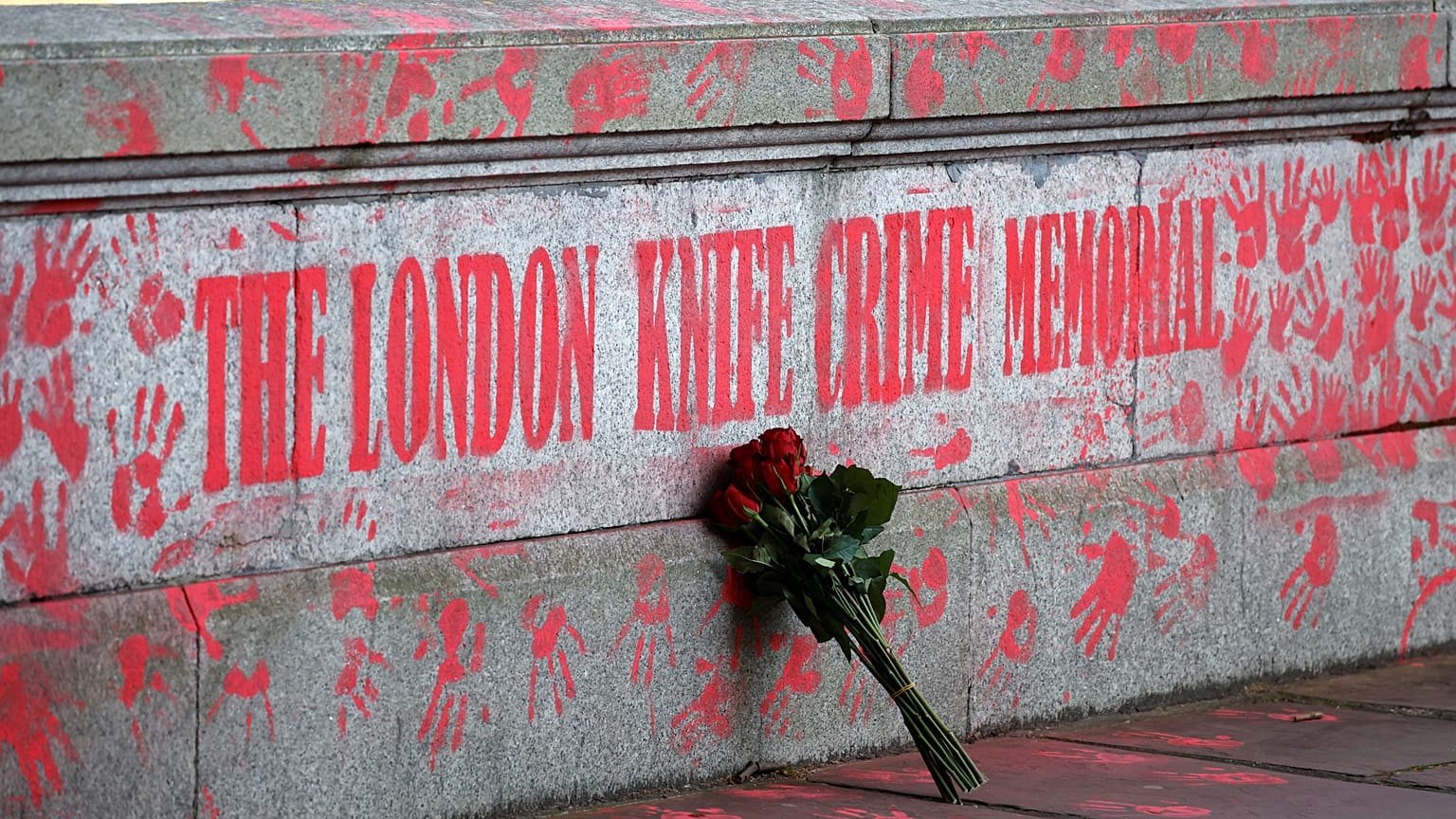 A bouquest is left at a mural to highlight knife crime in London on April 30, 2021.