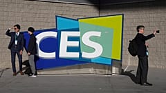 People take pictures in front of a sign during the CES tech show Thursday, Jan. 6, 2022, in Las Vegas.