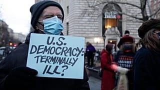 Activists hold a candlelight vigil for democracy on the National Mall