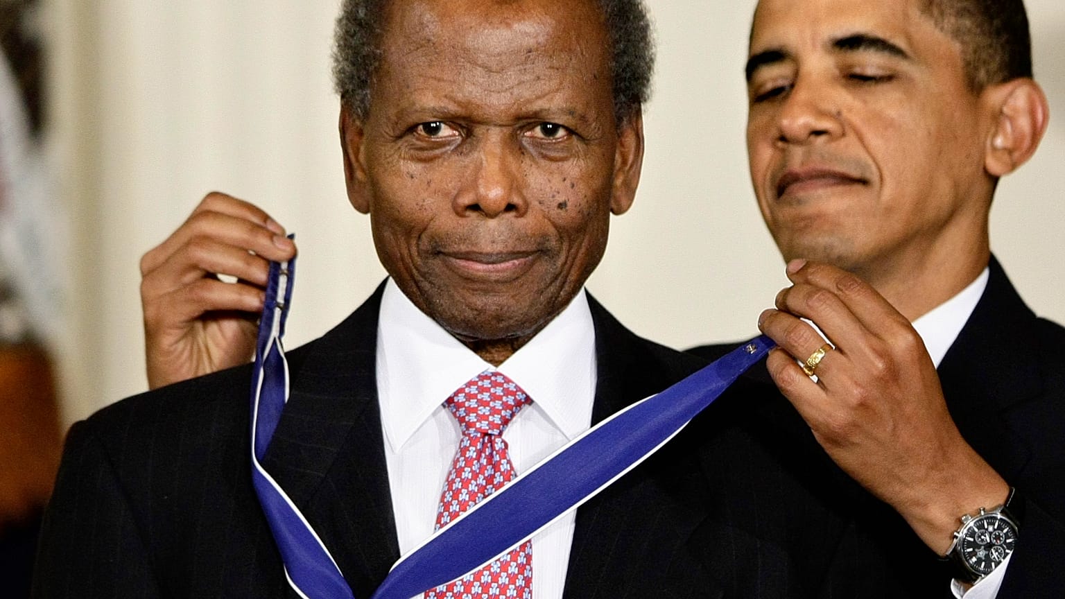 President Barack Obama presents the 2009 Presidential Medal of Freedom to Sidney Poitier during ceremonies in the East Room at the White House in Washington on, Aug. 12, 2009