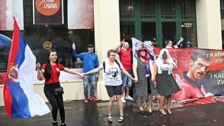 Protestors gather outside an immigration detention hotel where Serbia's Novak Djokovic is believed to stay, in Melbourne, Australia, Friday, Jan. 7, 2022.