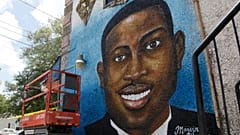FILE - A painted mural of Ahmaud Arbery is displayed on May 17, 2020, in Brunswick, Ga., where the 25-year-old man was shot and killed in February.
