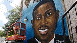 FILE - A painted mural of Ahmaud Arbery is displayed on May 17, 2020, in Brunswick, Ga., where the 25-year-old man was shot and killed in February.