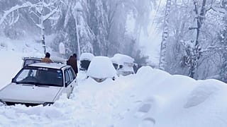 Vehicles trapped in a heavy snowfall-hit area in Murree