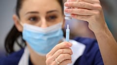 A medical staffer prepares a shot of Moderna COVID-19 vaccine, at a vaccination center in Ramsgate, England, Thursday, Dec. 16, 2021. 