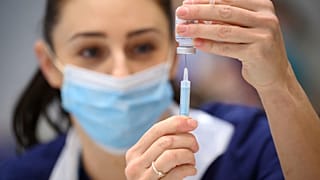 A medical staffer prepares a shot of Moderna COVID-19 vaccine, at a vaccination center in Ramsgate, England, Thursday, Dec. 16, 2021. 
