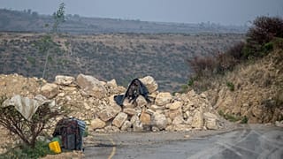 FILE: An Ethiopian government soldier mans a position where rocks have been placed to create a narrowing in a road leading to Abi Adi, in the Tigray region.