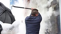 Employees of Democrats' Party use a fire extinguisher against protesters who try to invade at the headquarters in Tirana, Albania, Saturday, Jan. 8, 2022.