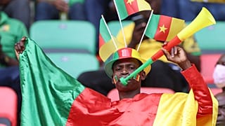 A Cameroonian football supporter cheers ahead of the opening ceremony of the Africa Cup of Nations (CAN) 2021 football tournament.