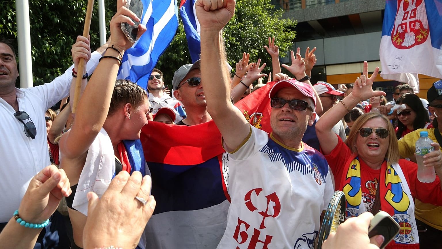 Fans of Serbia's Novak Djokovic react to news of his overturned ruling outside Federal Court ahead of the Australian Open in Melbourne, Australia, Monday, Jan. 10, 2022. 