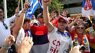 Fans of Serbia's Novak Djokovic react to news of his overturned ruling outside Federal Court ahead of the Australian Open in Melbourne, Australia, Monday, Jan. 10, 2022. 