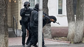 Fegyveres rohamrendőrök őrizetbe vesznek egy tüntetőt Almatiban