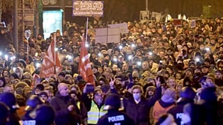 Protestors attend a demonstration against coronavirus restrictions and compulsory vaccinations, in Lubeck, Germany, on Jan. 10, 2022.