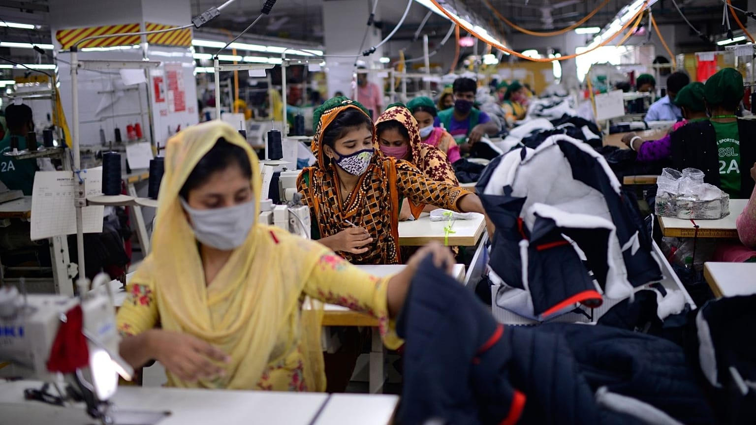 Garment employees work in the sewing section of a factory in Savar, Bangladesh.