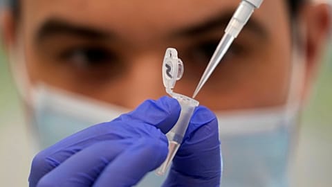 Research assistant Robert demonstrates how to prepare a sample for sequencing at the Wellcome Sanger Institute, Genome Campus, Hinxton, Cambridgeshire, England