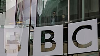 In this Thursday, March 28, 2013 file photo, people look out from inside BBC's New Broadcasting House, in central London
