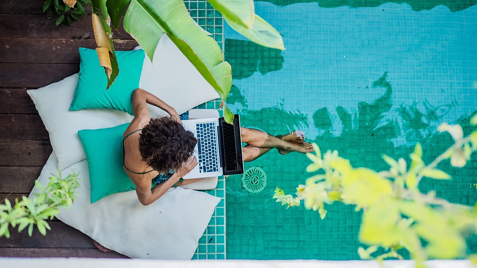 A woman works by a swimming pool 