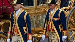 Footmen walk alongside the Golden Carriage as Netherlands' King Willem-Alexander and Queen Maxima arrive at Noordeinde Palace in 2013.
