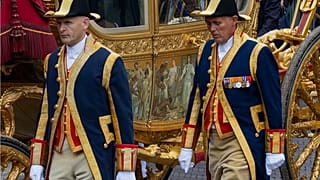 Footmen walk alongside the Golden Carriage as Netherlands' King Willem-Alexander and Queen Maxima arrive at Noordeinde Palace in 2013.