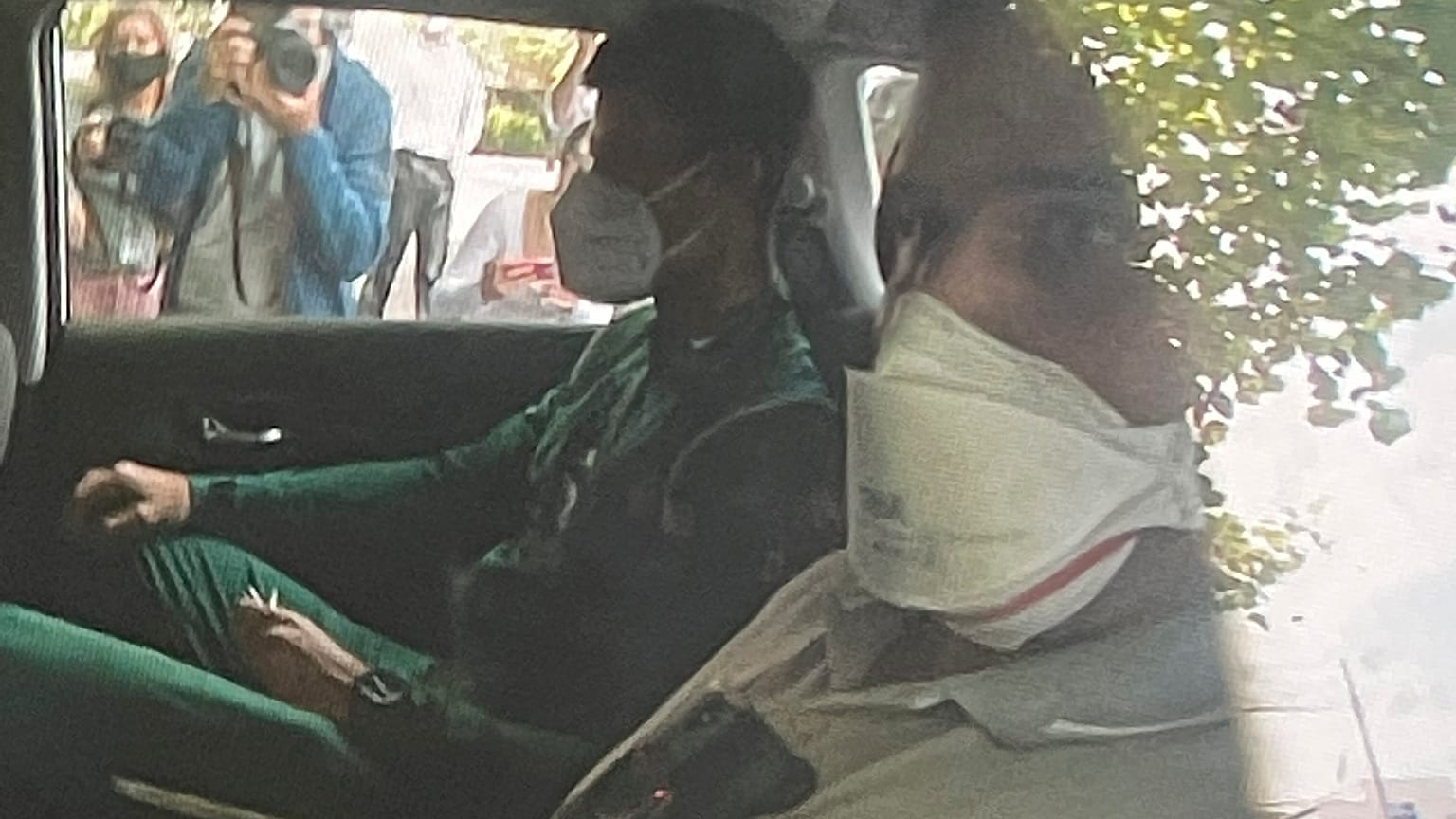 Novak Djokovic sits in the back of car arriving at an immigration detention hotel in Melbourne, Australia Saturday, Jan. 15, 2022.