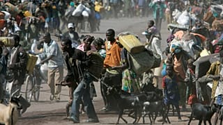 Straßenszene in Goma. Viele Menschen schleppen Wasserkanister