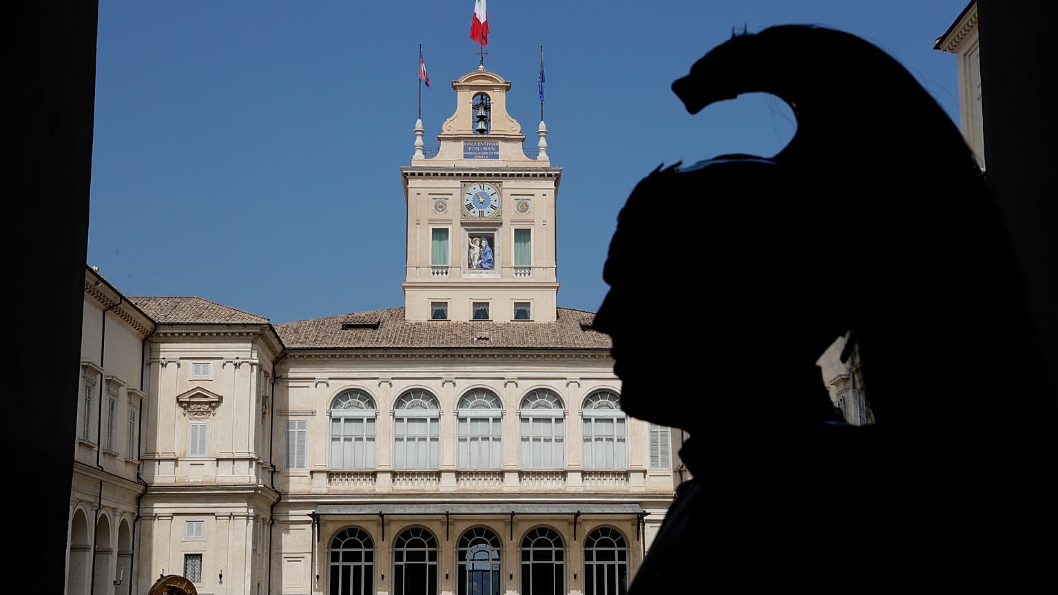 A Courassier presidential guard is silhouetted in the courtyard of Rome's Quirinale presidential palace, Thursday, Aug. 29, 2019