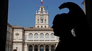 A Courassier presidential guard is silhouetted in the courtyard of Rome's Quirinale presidential palace, Thursday, Aug. 29, 2019