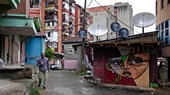A man walks through northern, Serb-dominated part of ethnically divided town of Mitrovica, Kosovo, Friday, Oct. 15, 2021.