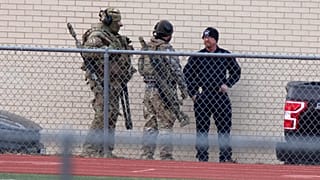 Law enforcement officials gather at a local school near the Congregation Beth Israel synagogue on Jan. 15, 2022 in Colleyville, Texas.