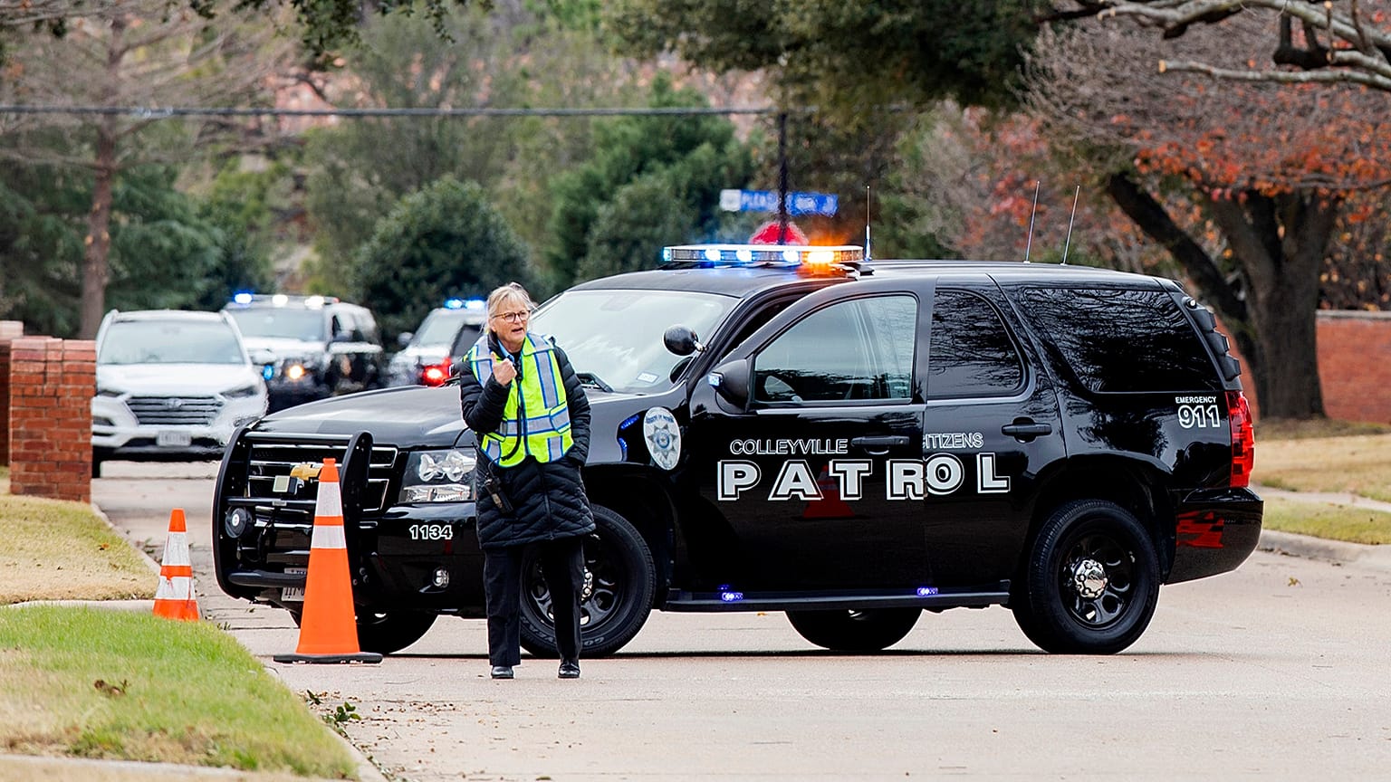 Law enforcement officials block a residential street near Congregation Beth Israel synagogue where a man took hostages during services on Saturday, January 15