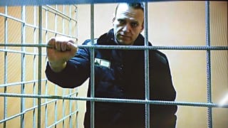 Russian opposition leader Alexei Navalny looks at a camera while speaking from a prison via a video link, during a court session in Petushki, Russia, on Jan. 17, 2022.
