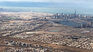 صورة جوية لخليج دبي وتظهر في الخلفية البعيد عاصمة الإمارات، أبوظبي
